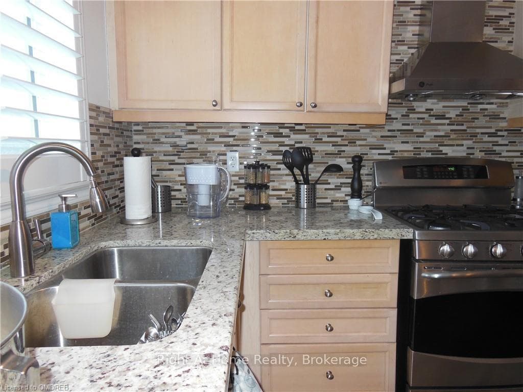 Kitchen featuring wall chimney exhaust hood, sink,