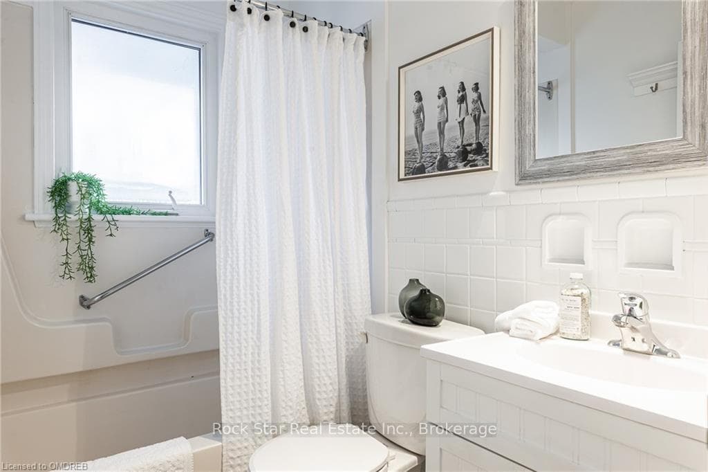 Full bathroom with decorative backsplash, vanity,