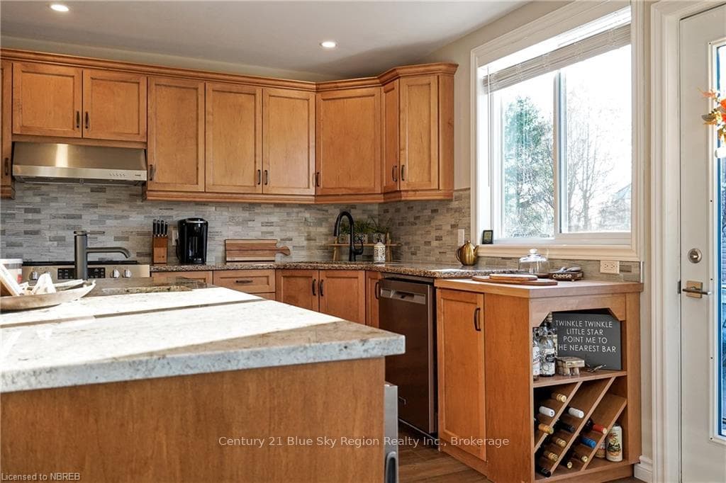 Kitchen featuring decorative backsplash, appliance