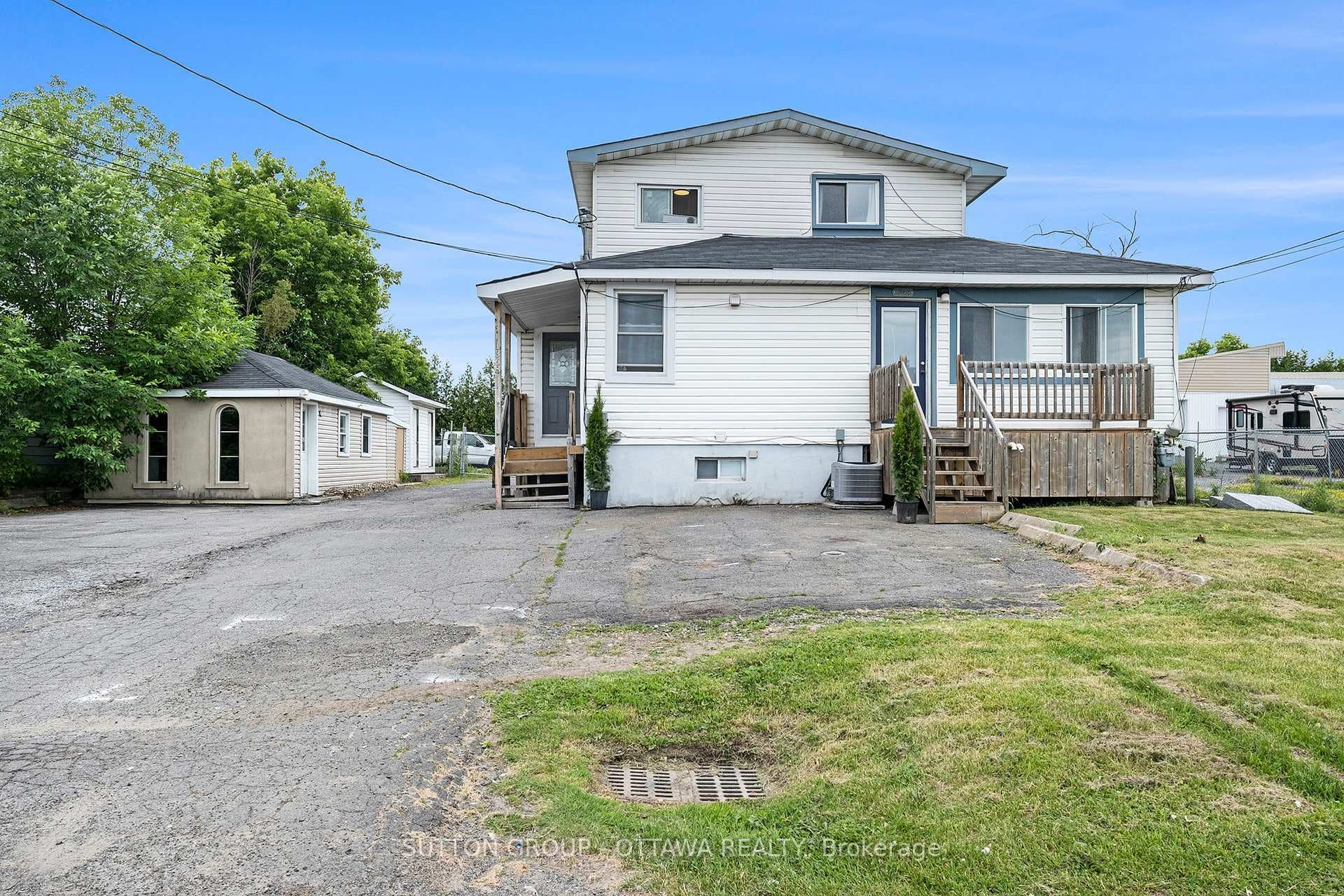 Triplex with Outbuildings on Side of Property