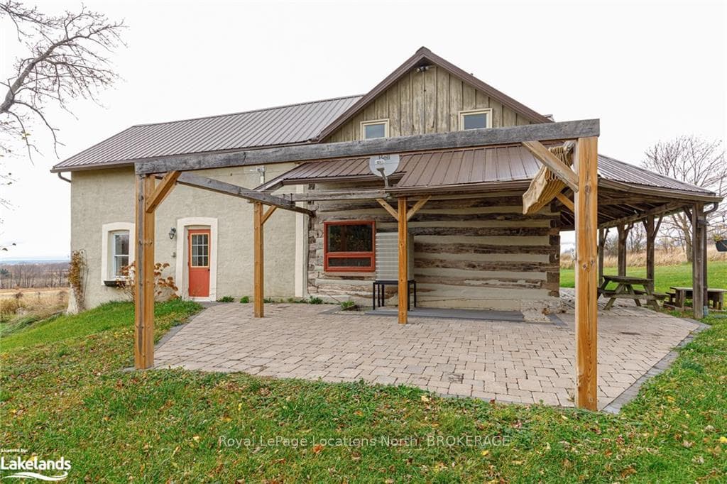 Back of property featuring a lawn and a patio area