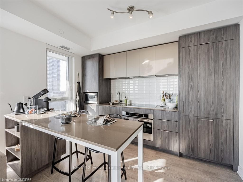 Kitchen featuring sink, a kitchen breakfast bar, t