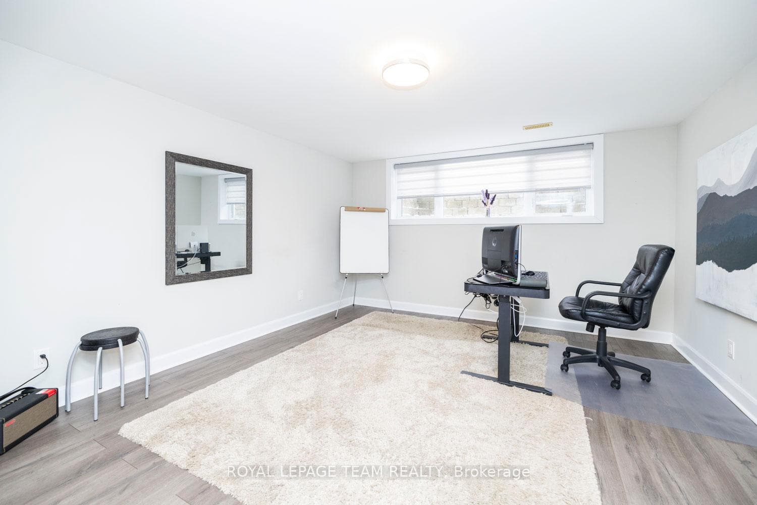 Bright lower-level bedroom with window.