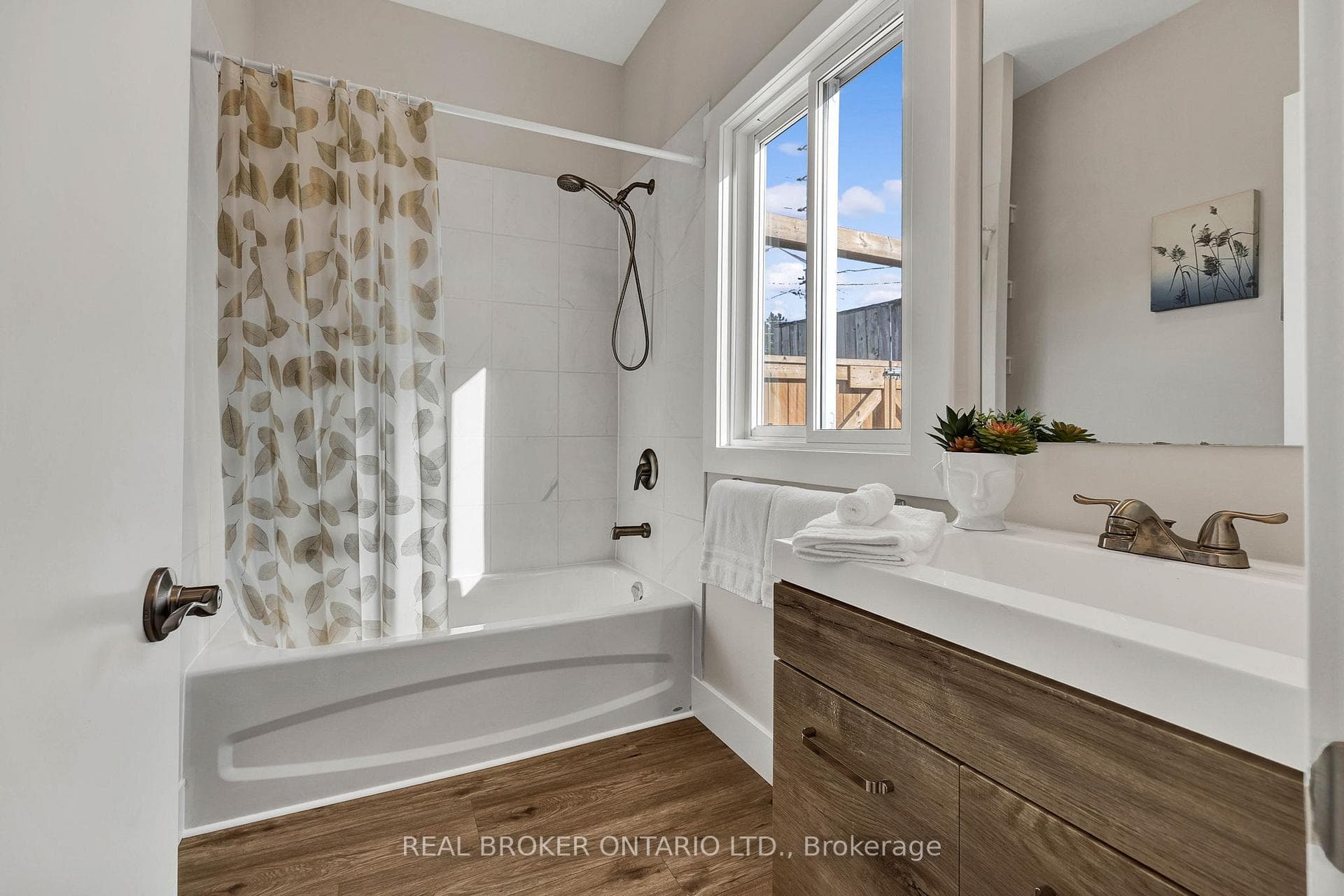 Bathroom featuring shower / tub combo, vanity