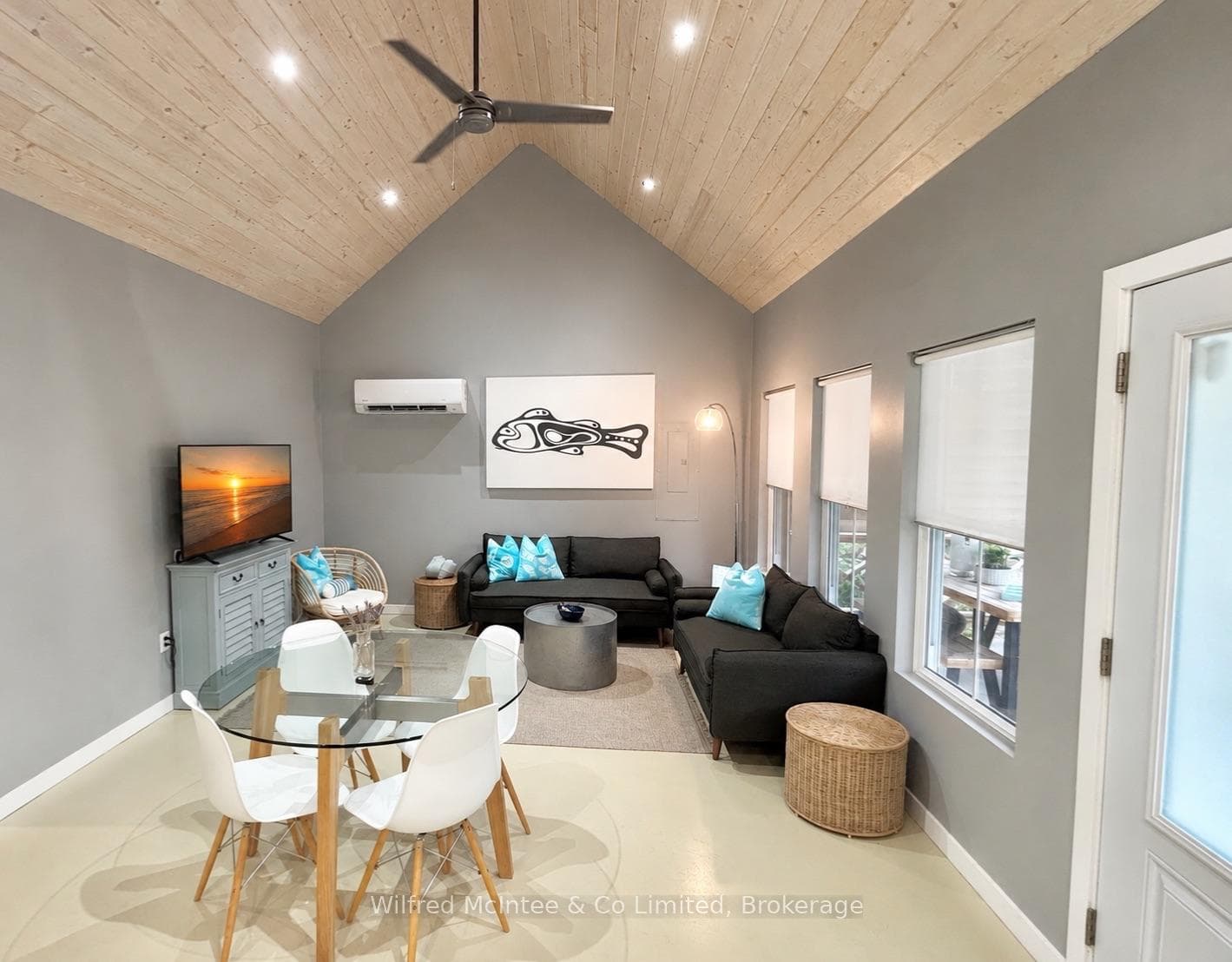 Bright, open living area with vaulted pine ceiling