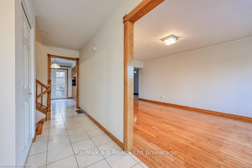 Corridor with light hardwood / wood-style flooring