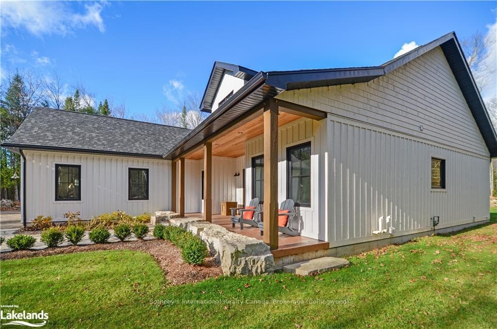 Rear view of property featuring a yard and covered