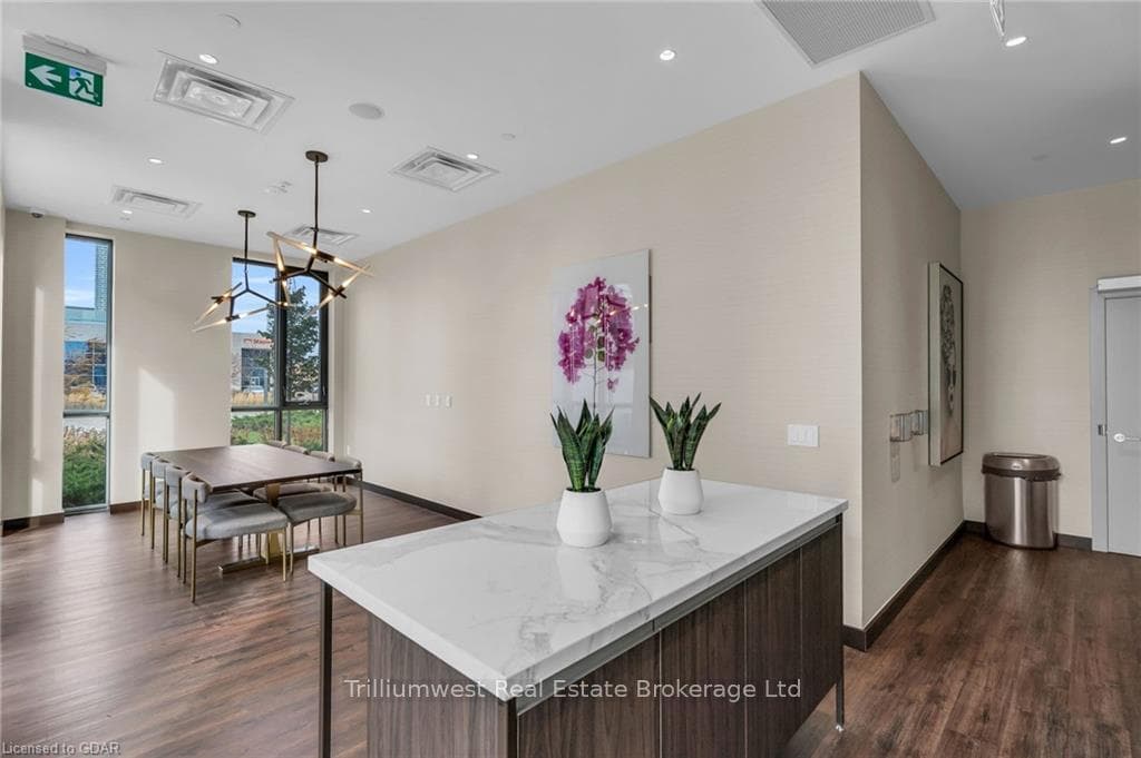 Kitchen with dark brown cabinetry, dark hardwood /