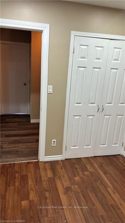 Corridor featuring dark hardwood / wood-style floo