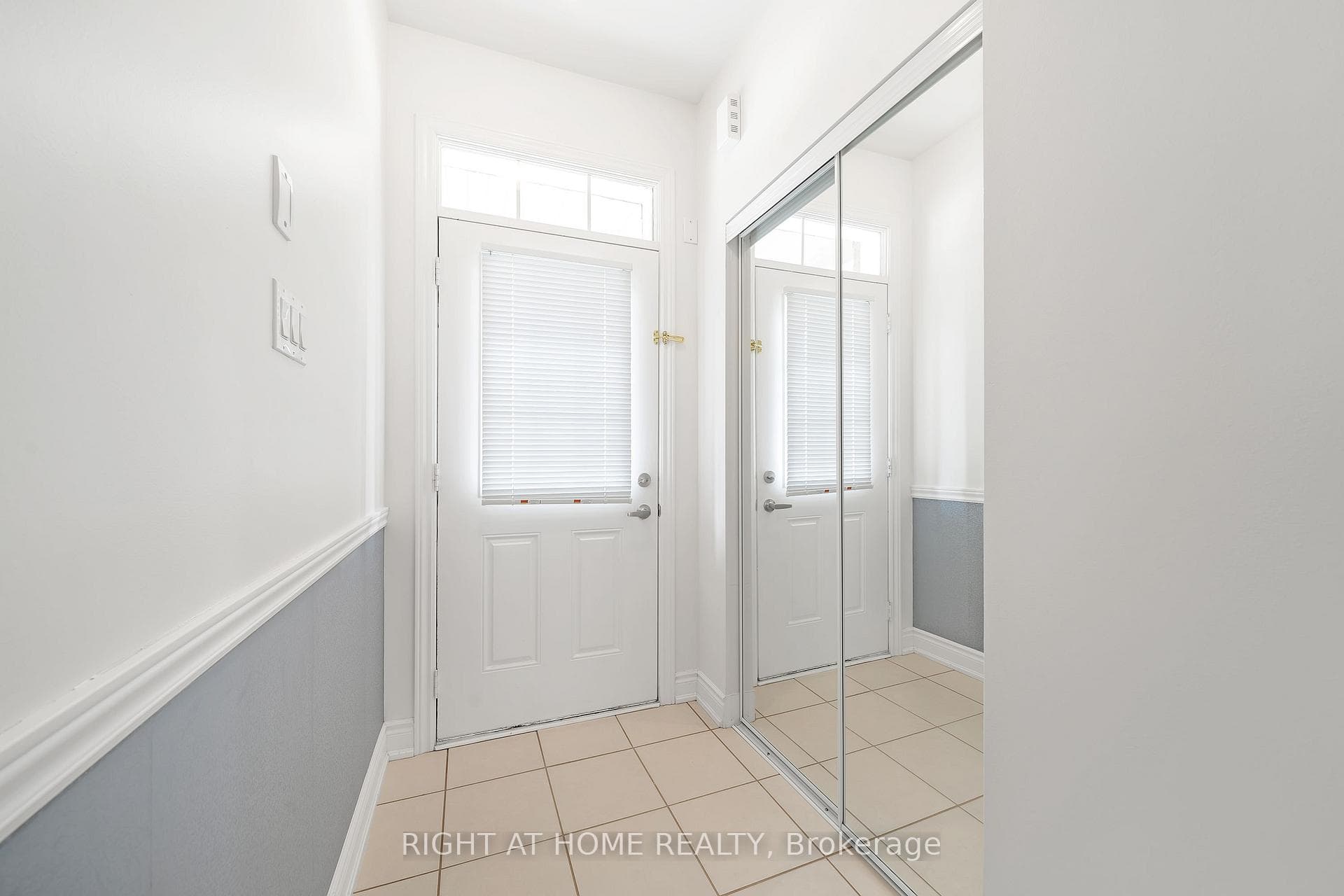 ceramic foyer and mirror closet doors at entrance