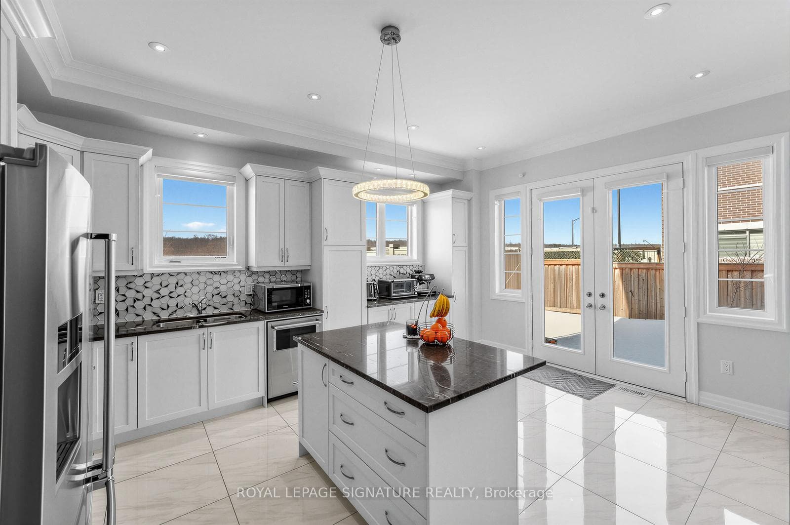 Chef's kitchen with island and walkout to backyard