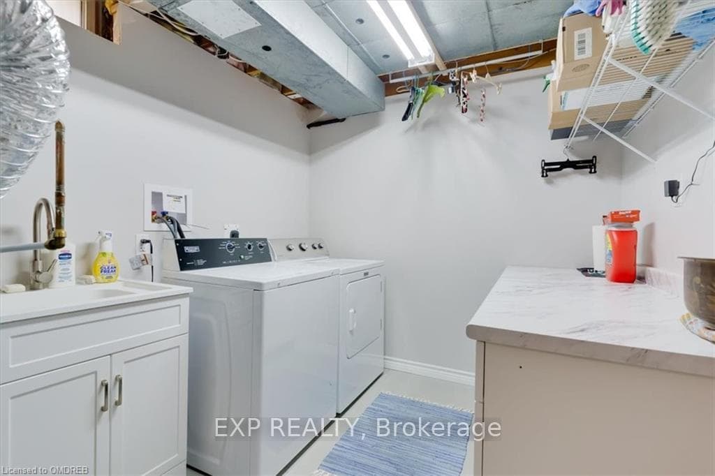 Laundry located in the basement with storage