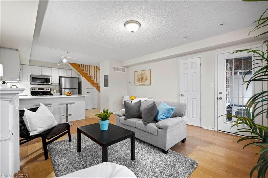 Living room with a textured ceiling and light hard