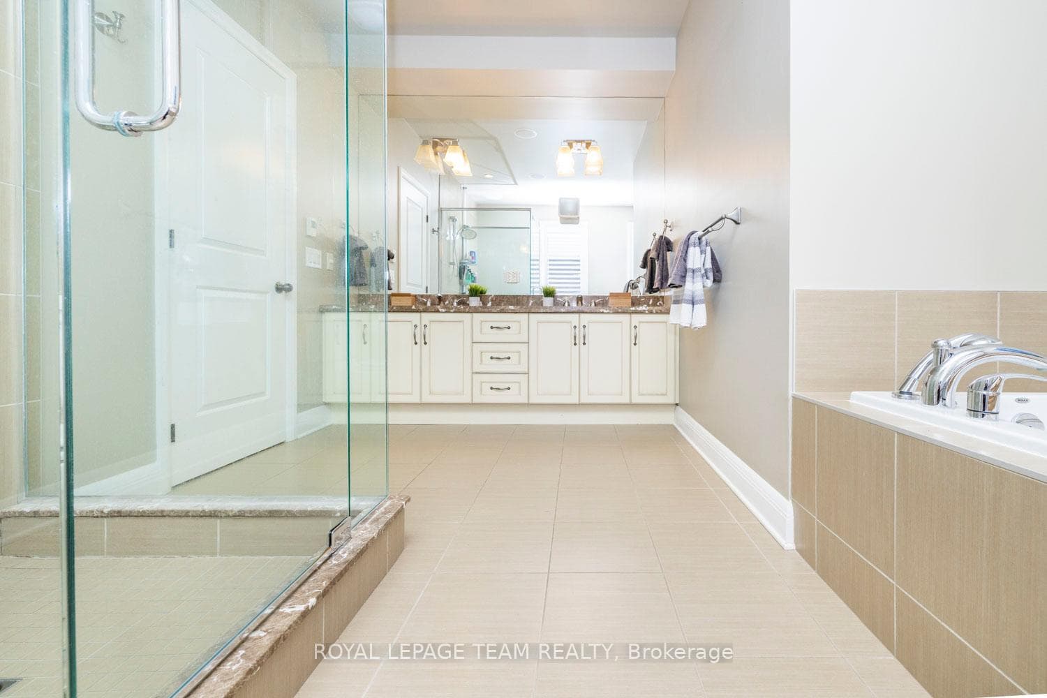 Luxurious ensuite with glass shower & soaker tub.