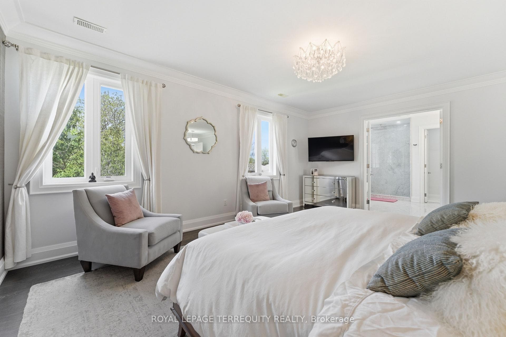 Serene primary bedroom with seating lounge..