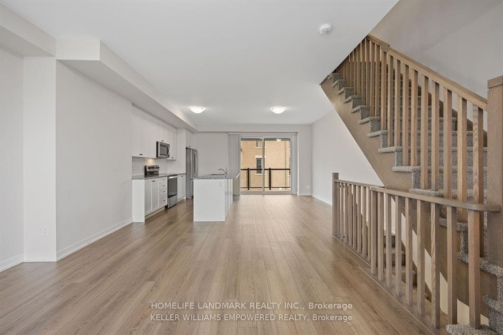 Living room to kitchen angled at stairs