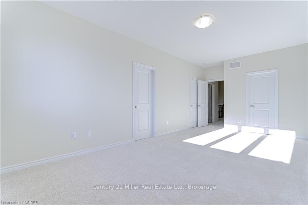 Unfurnished bedroom with light colored carpet