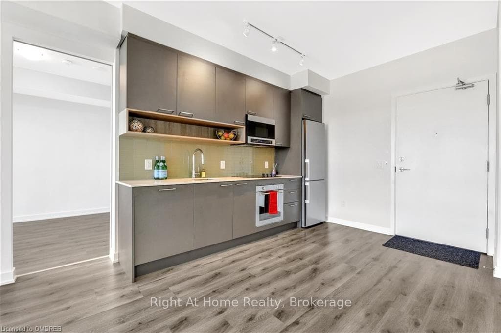 Kitchen featuring stainless steel appliances, back