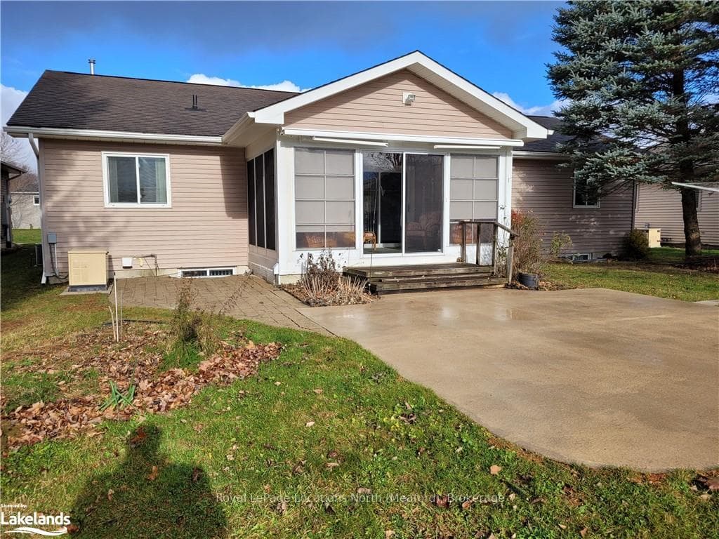 Back of house with a patio and generator.
