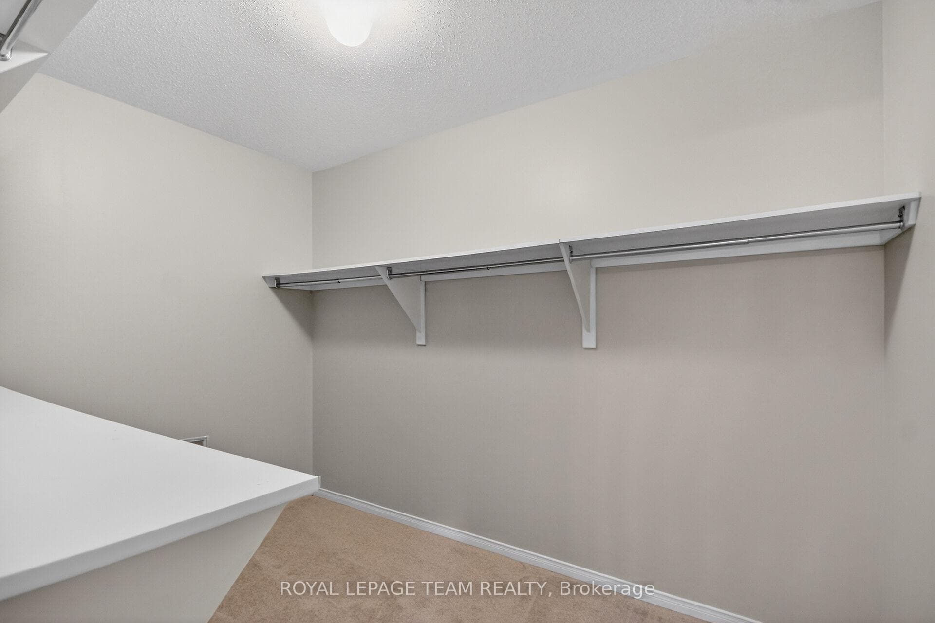 Primary bedroom walk-in closet