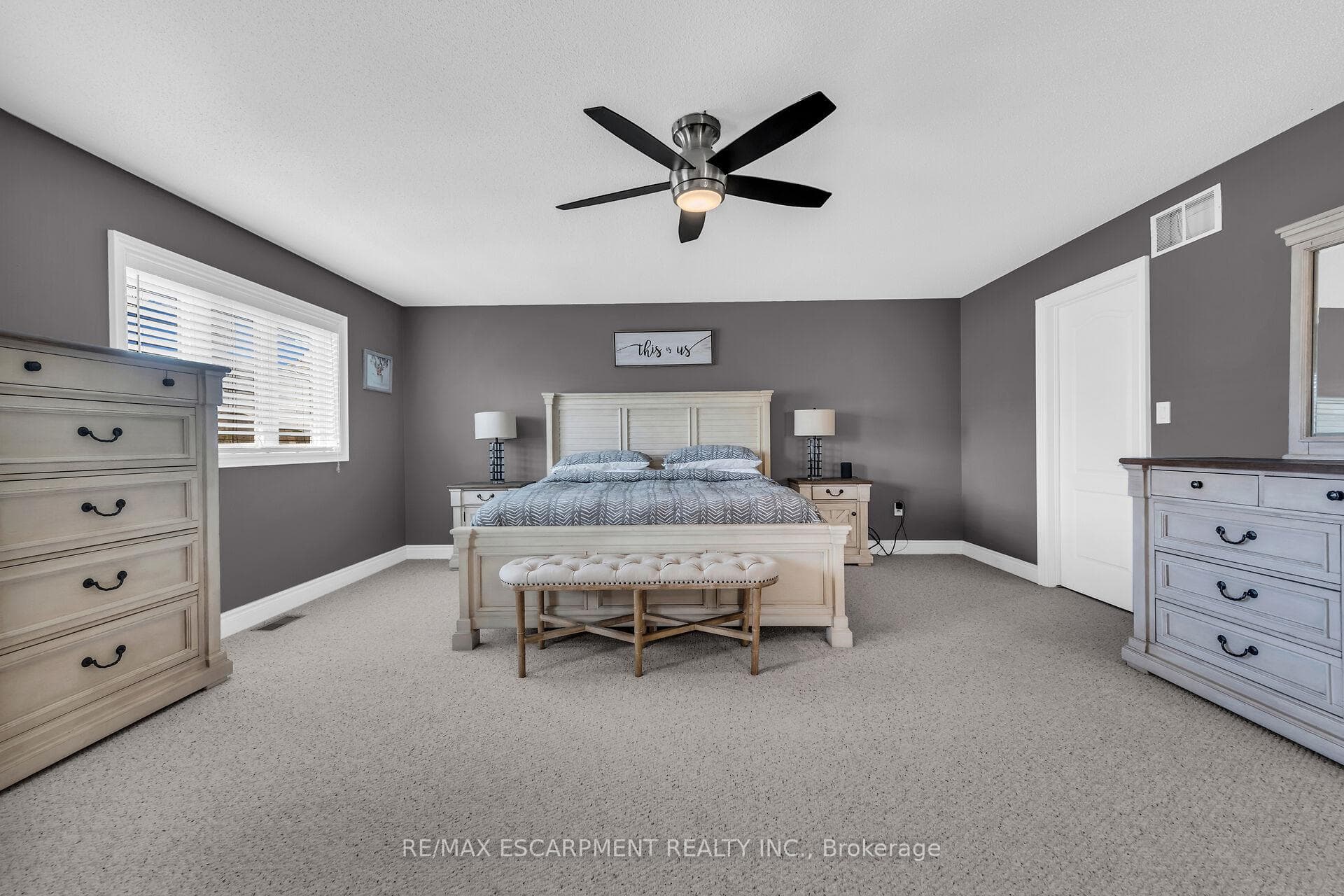 Bedroom with light colored carpet and ceiling fan
