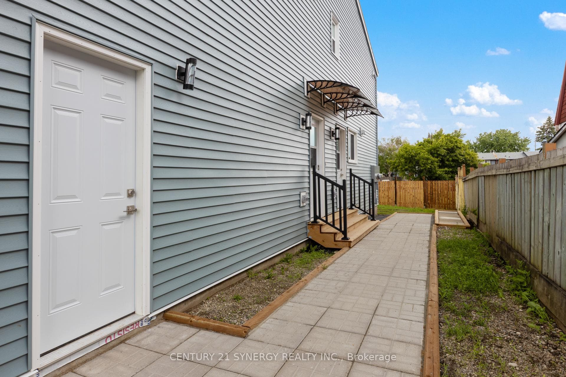 Side entrance. First door is to unit 93C.