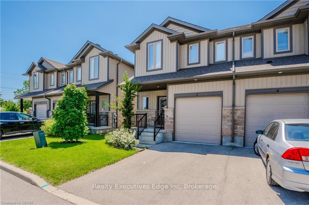 Multi unit property featuring a front lawn and a g