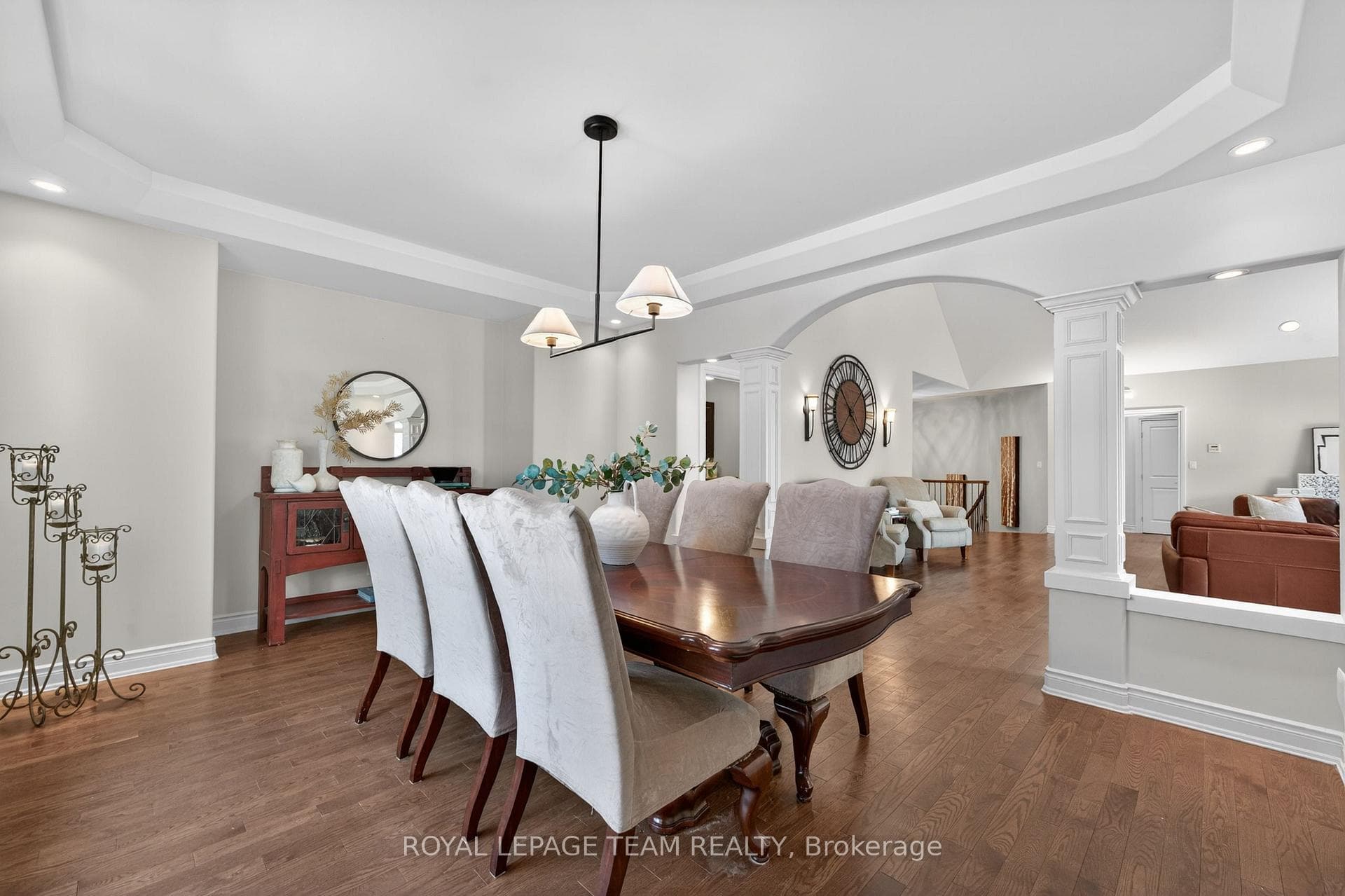 Formal dining room with pillars and wood floors