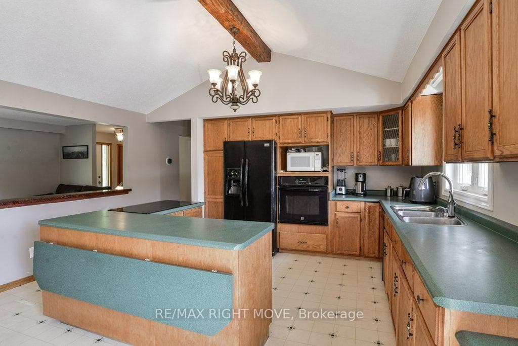 Oak cabinets; centre island with breakfast bar.