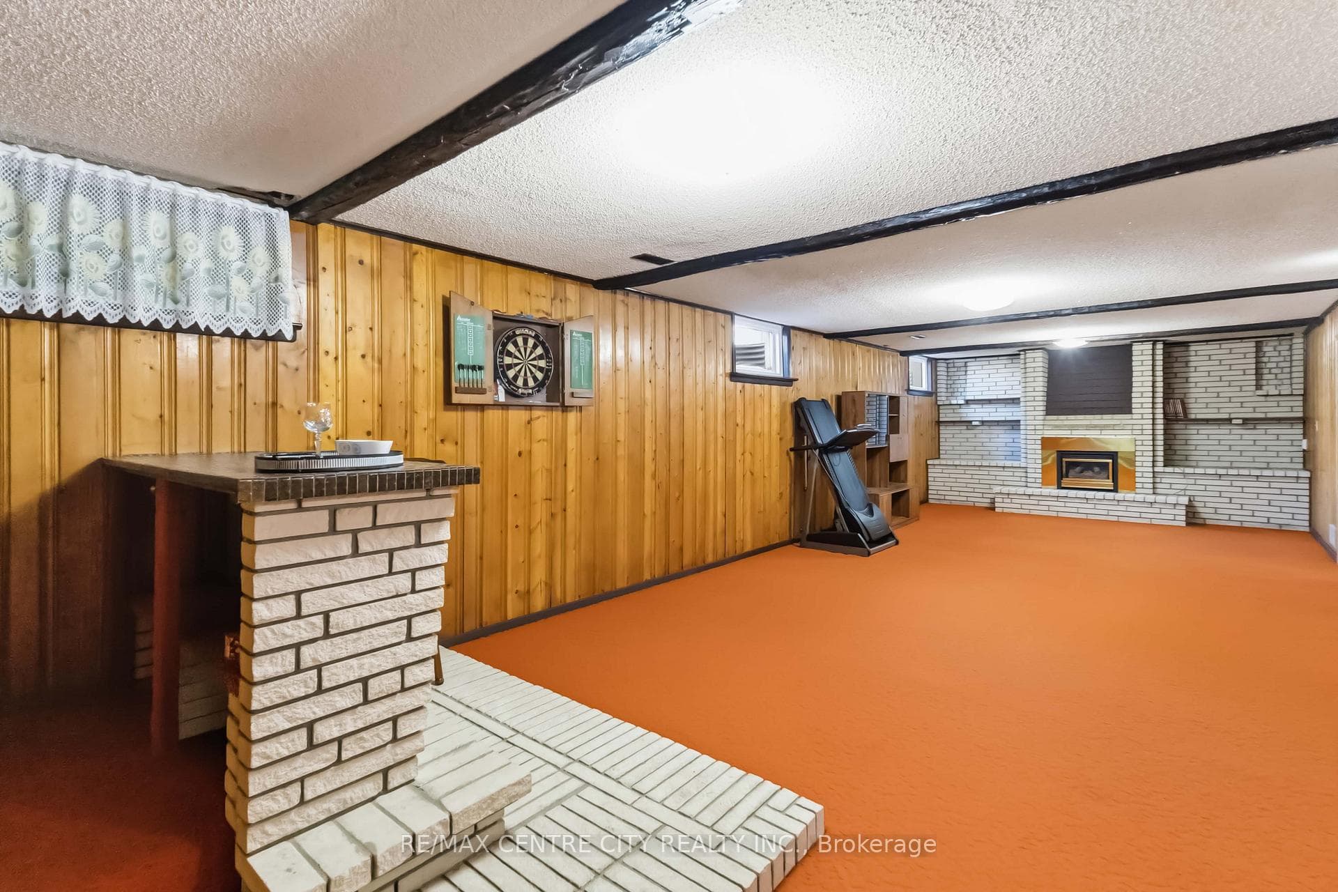 Finished basement with bar and fireplace