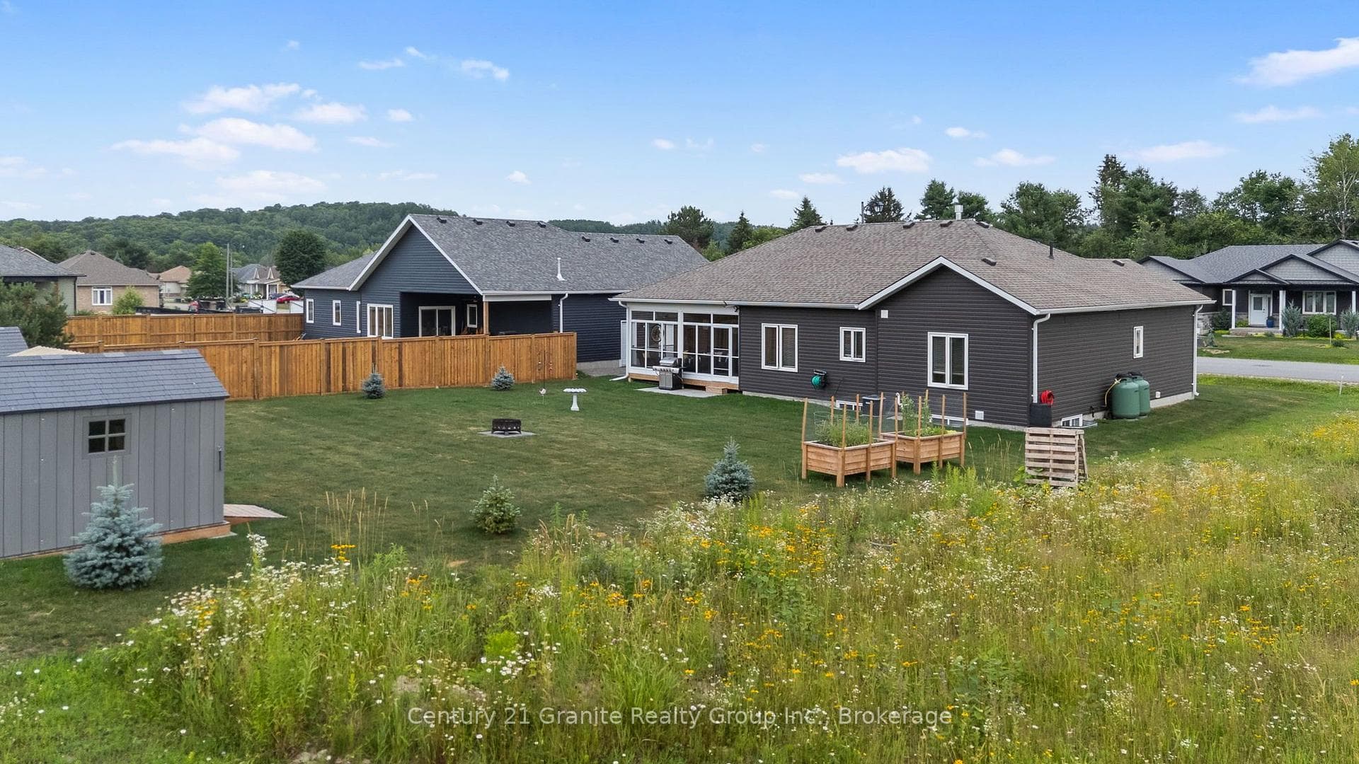 LARGE BACKYARD WITH STORAGE SHEDS/WOOD SHED