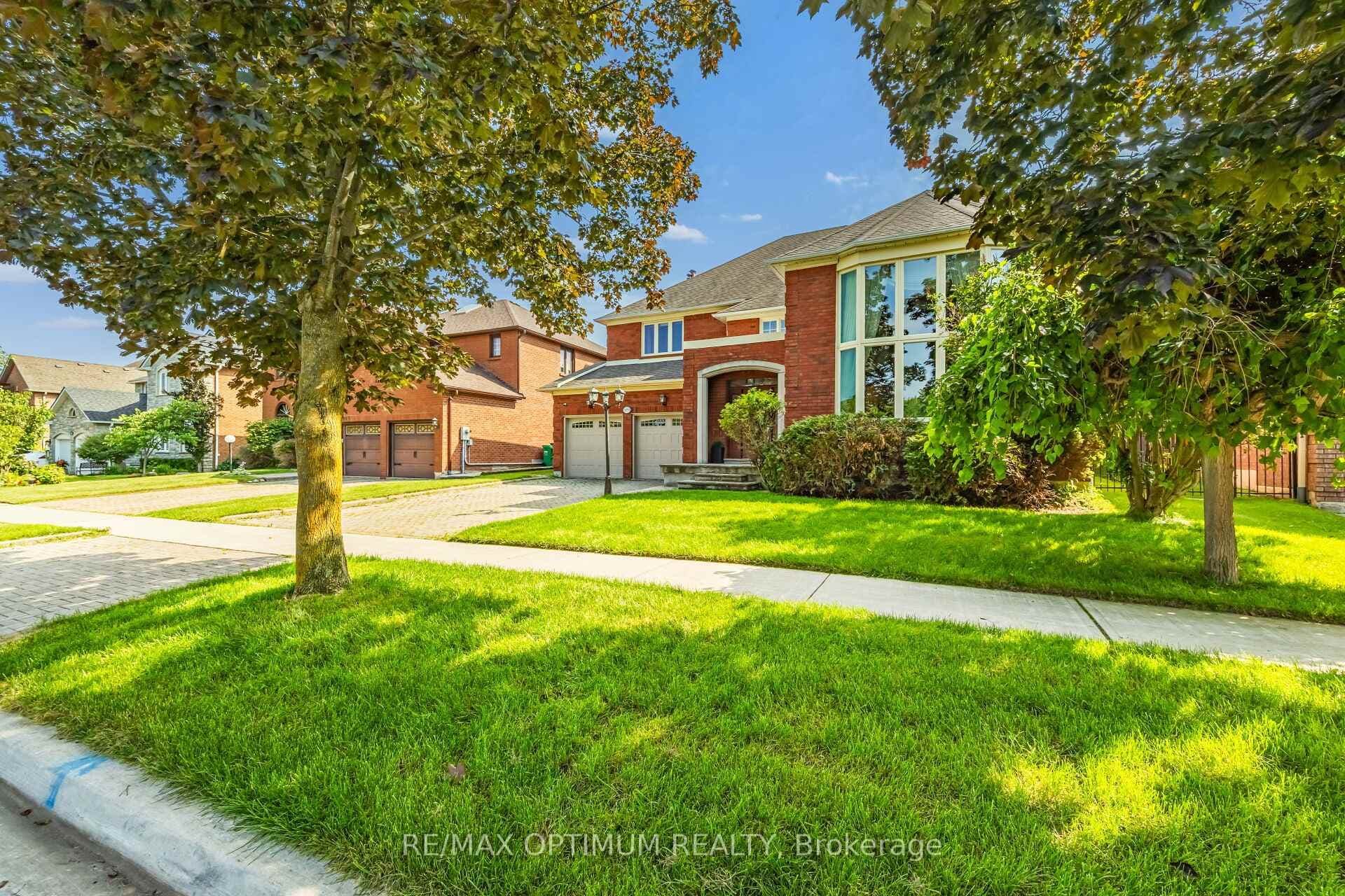 Tree-lined street & manicured front lawn