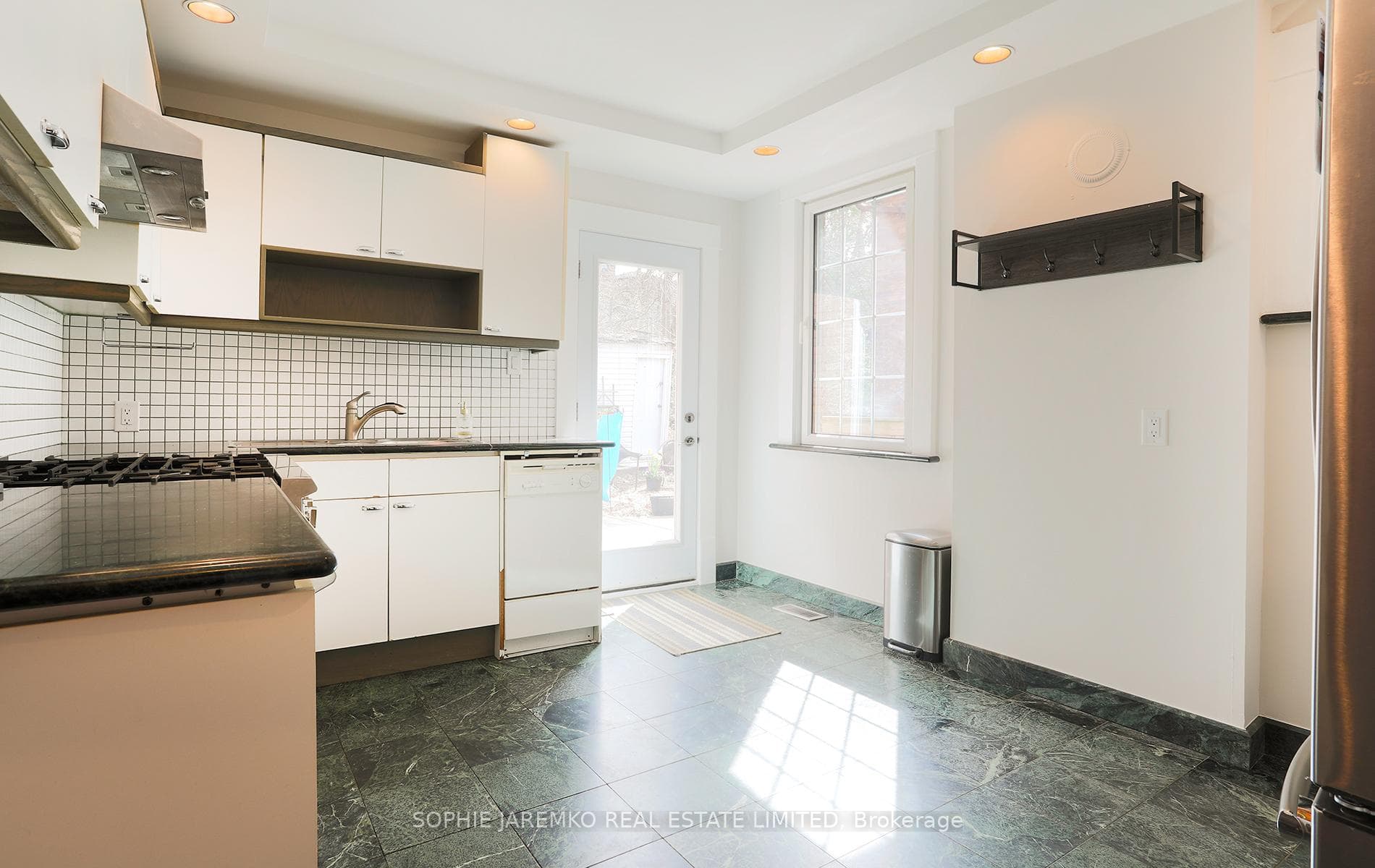 Main floor kitchen - west walk out to backyard