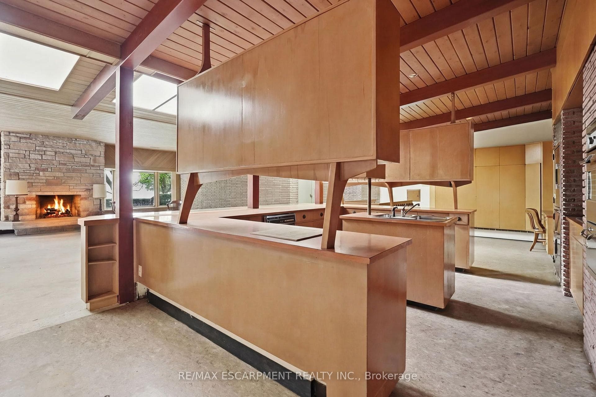 Kit. featuring light wood cabinetry, dual sinks,