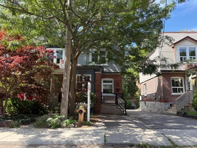 Leafy tree-lined front yard