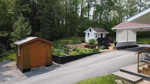 2 Sheds with beautiful Gardens