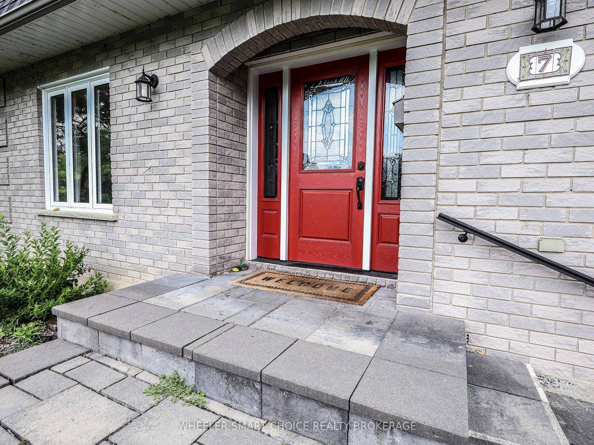 The impressive red door offers a pop of colour.