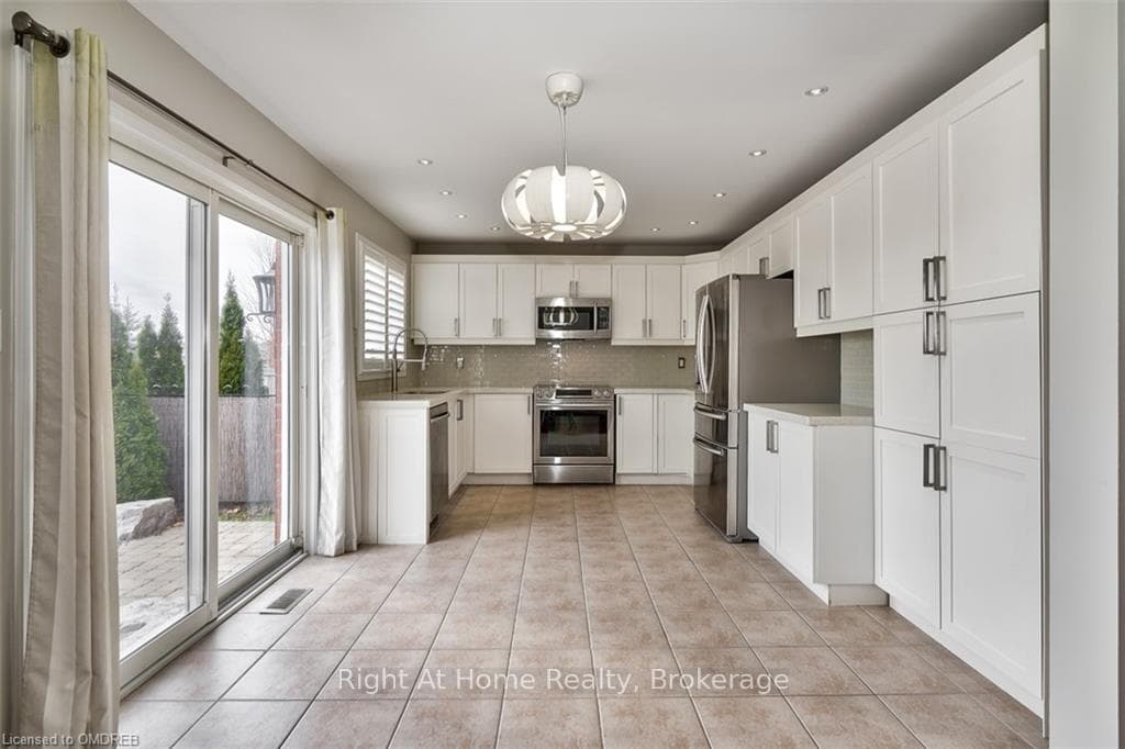Kitchen featuring pendant lighting, appliances wit