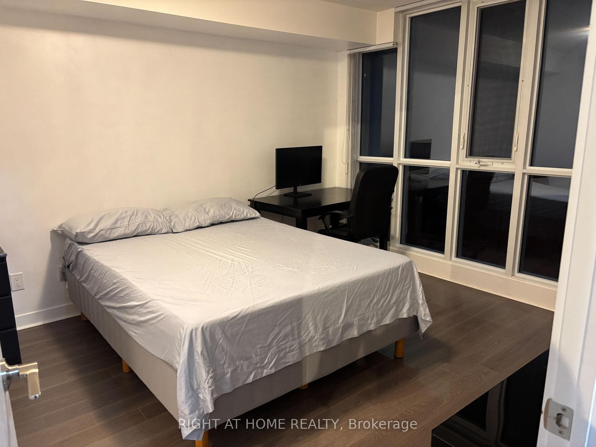 Primary bedroom fits a queen bed and work space.