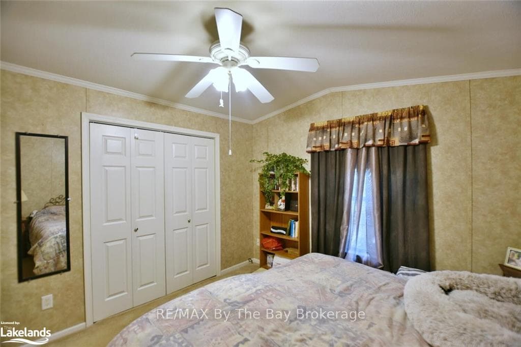 Bedroom with ceiling fan, carpet, lofted ceiling,