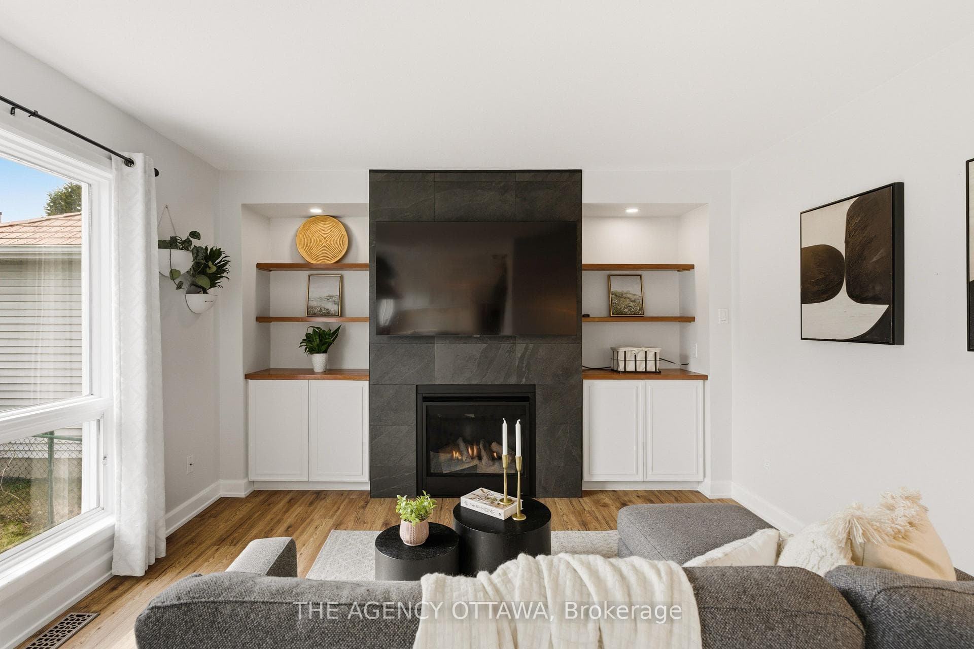 Cozy living room w/ gas fireplace & wood shelving