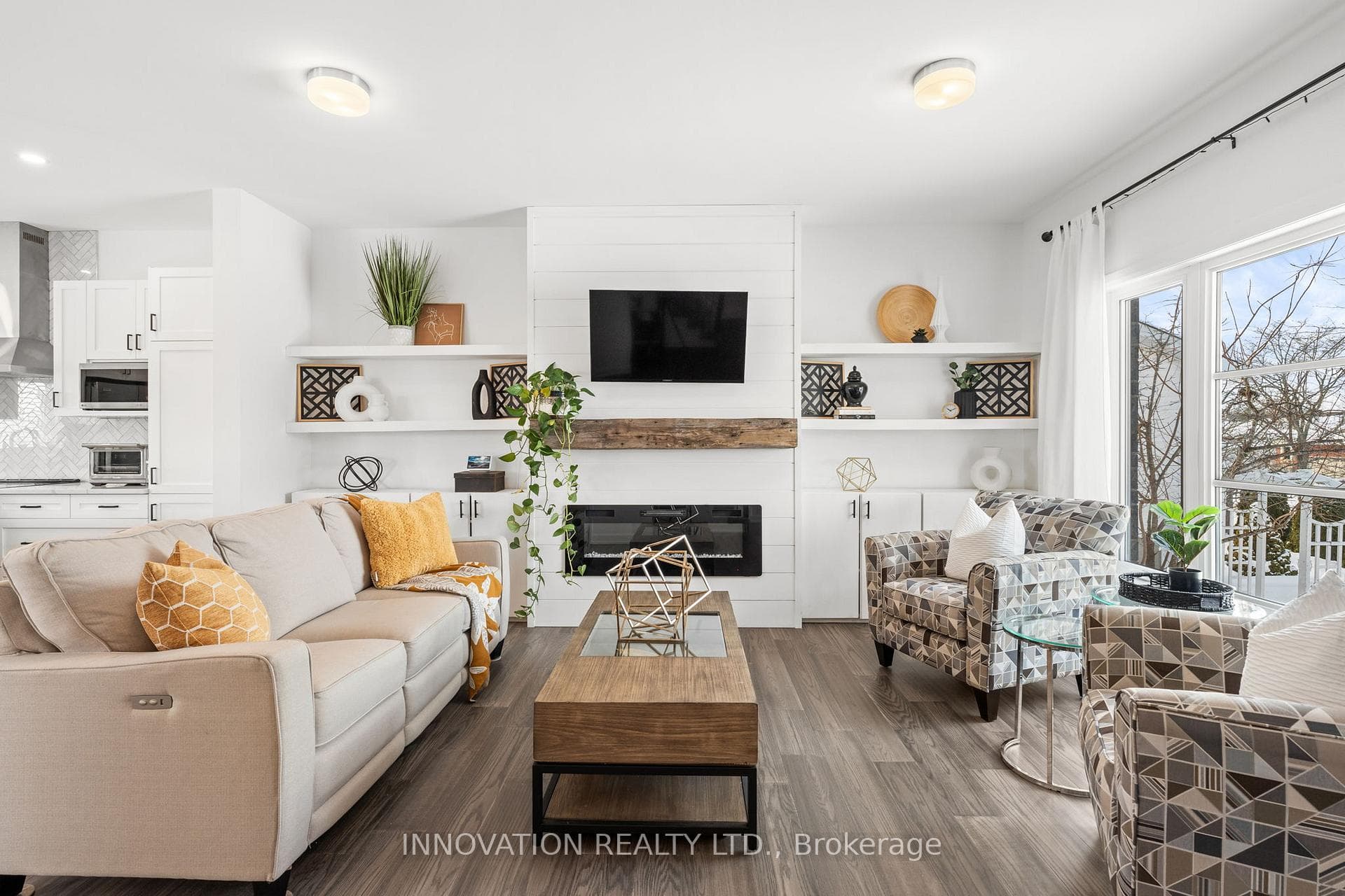 Open concept living room with electric fireplace.
