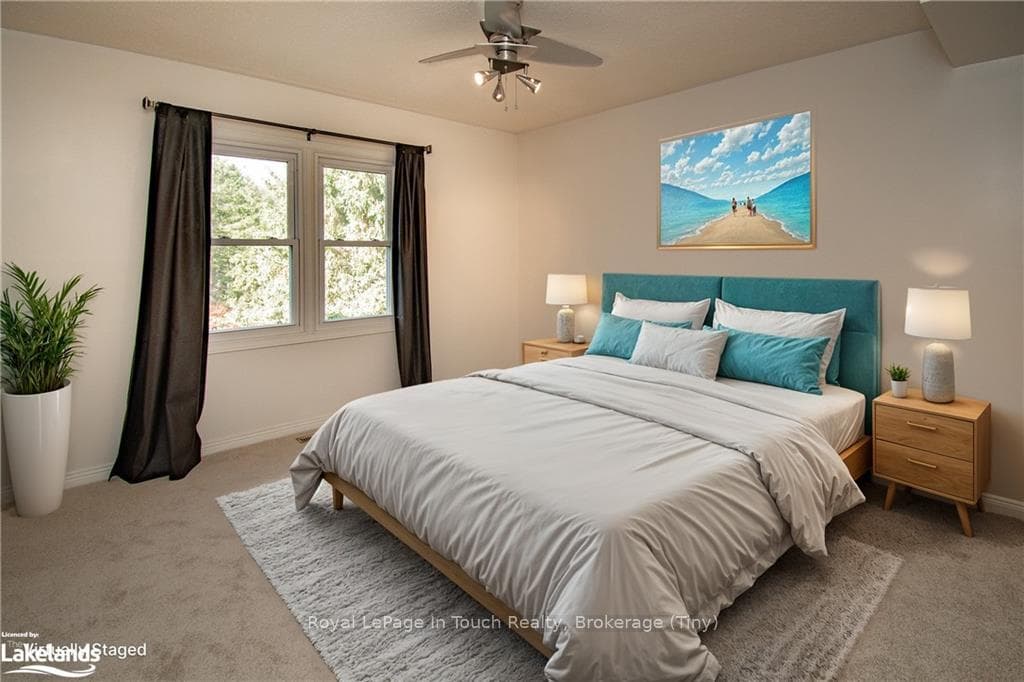 Bedroom with ceiling fan and light carpet
