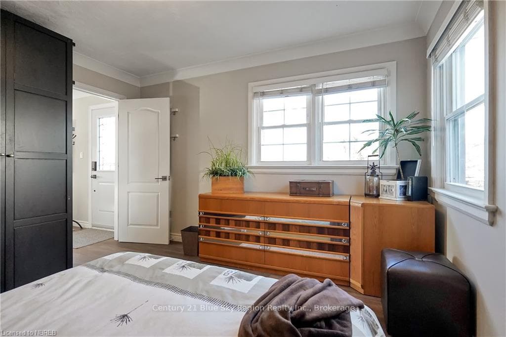 Bedroom featuring crown molding and hardwood / woo