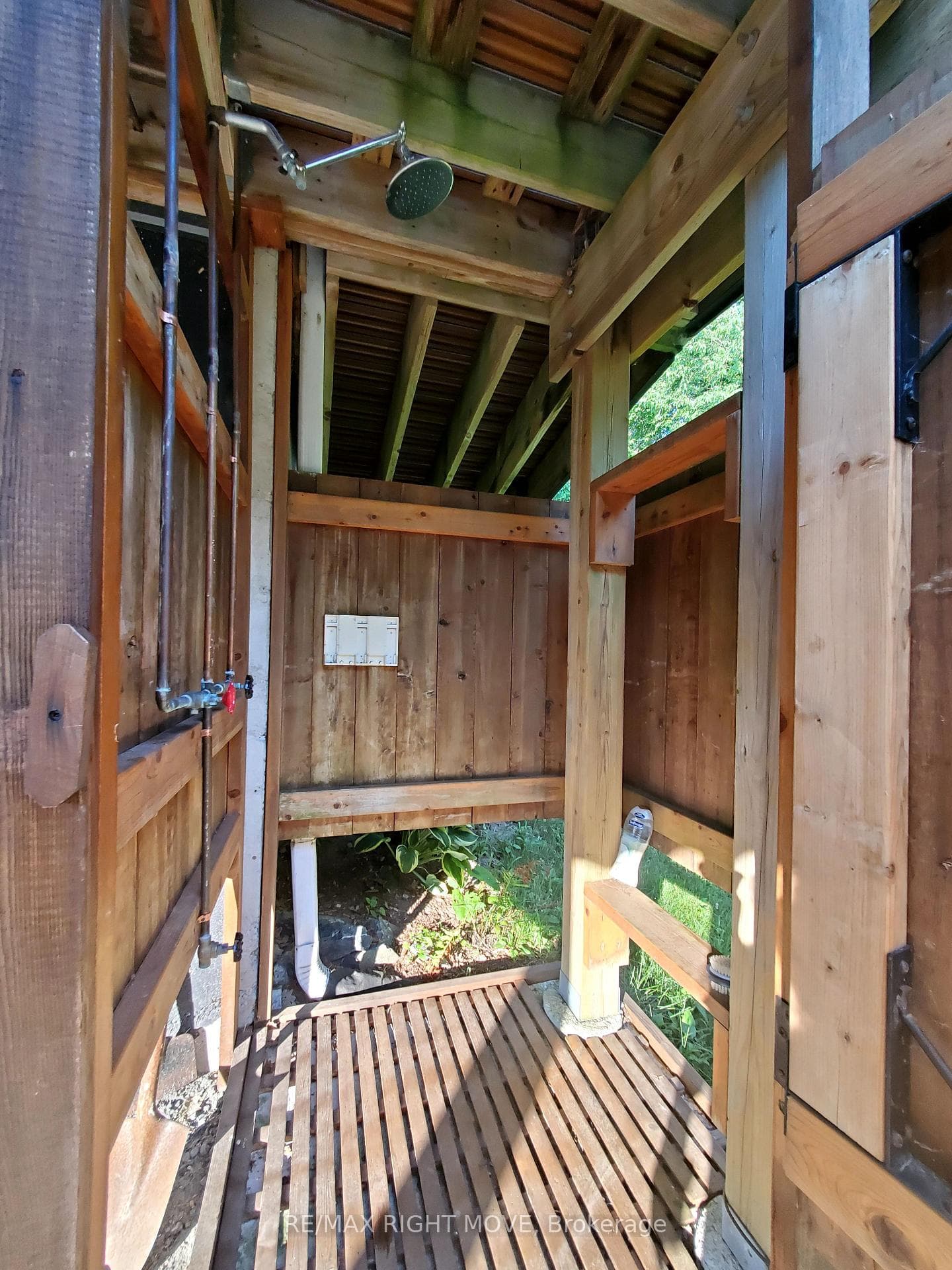 Oudoor cedar shower by sauna and swimming pool