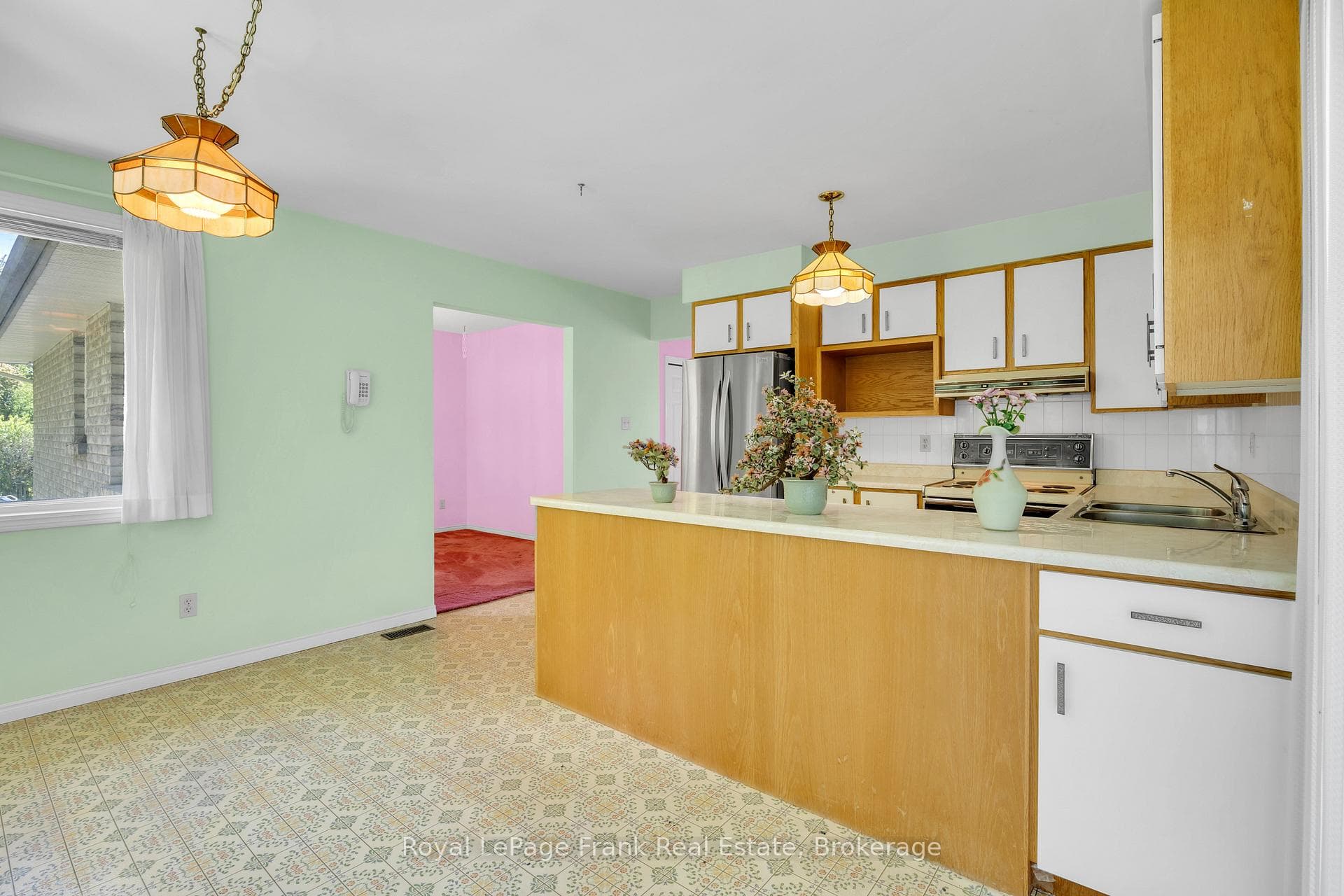 Kitchen with 3 large windows and walkout to deck