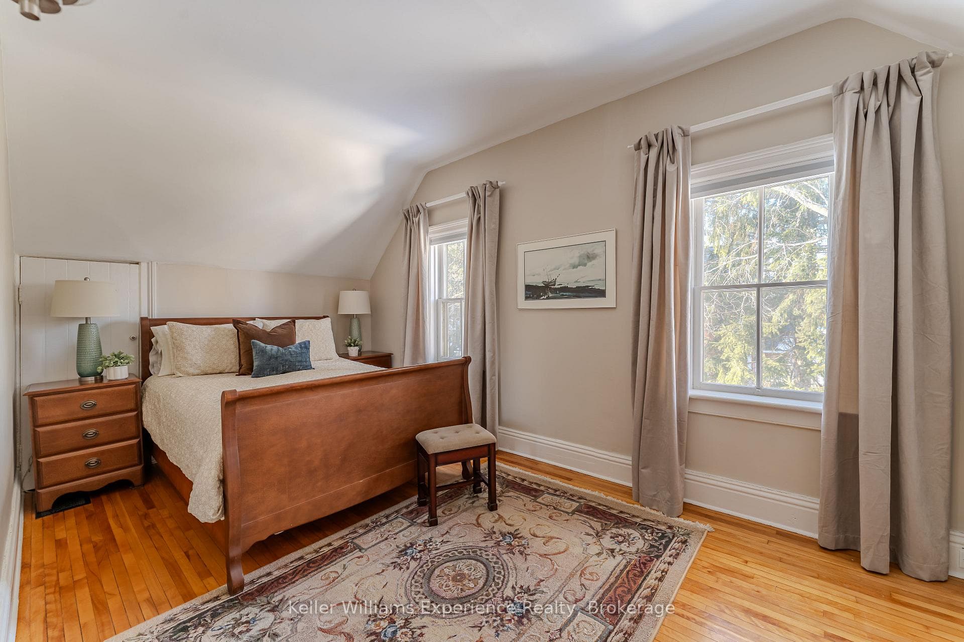Second bedroom with hardwood floors & tall windows