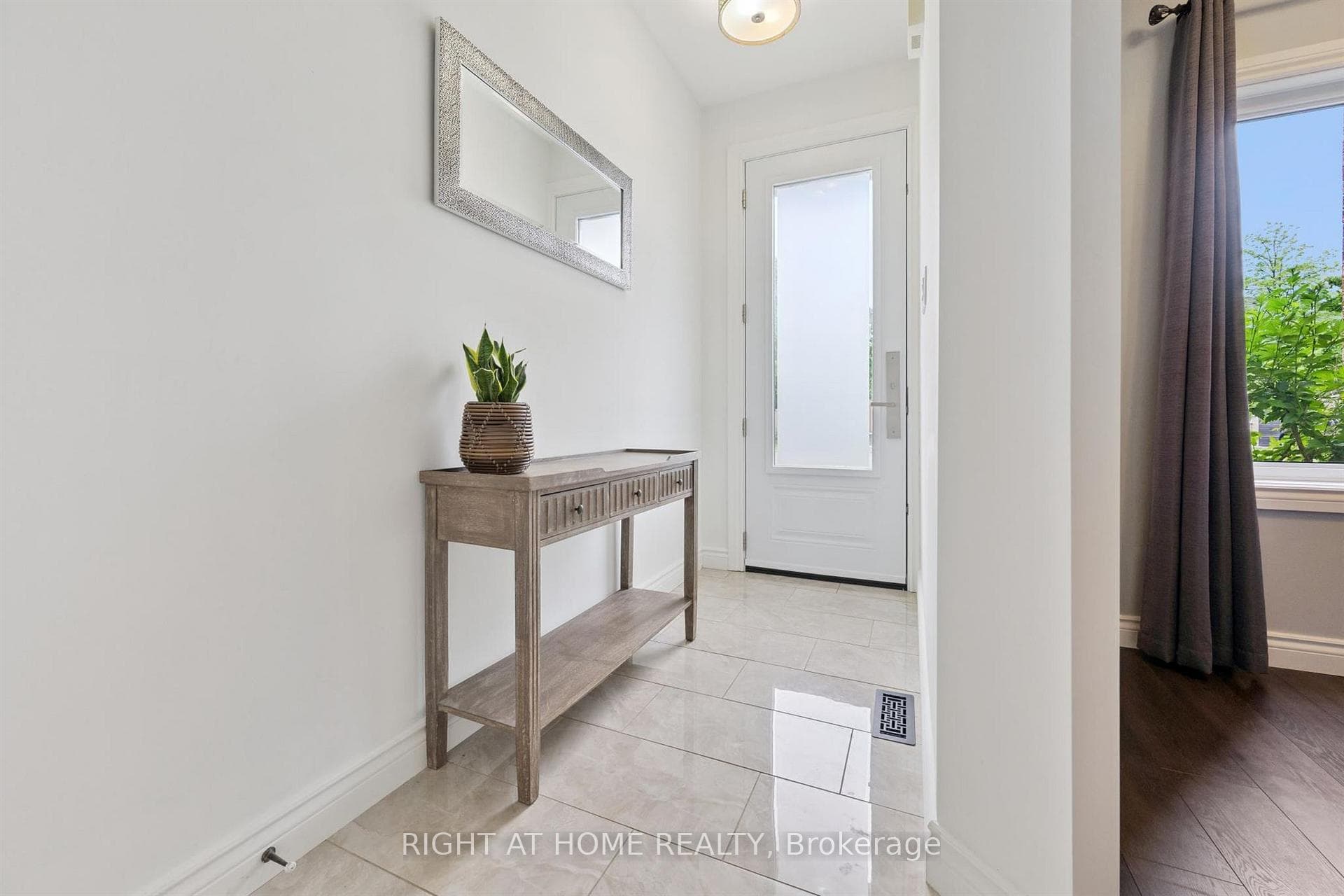 generous foyer with gleaming porcelain tile.