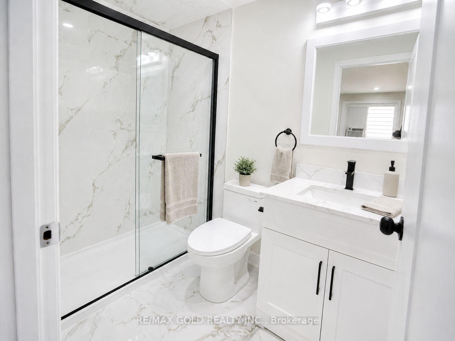 Fully renovated bathroom with glass shower enclos.