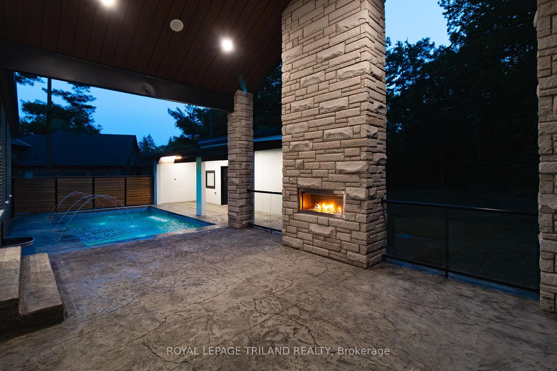 Gas Fireplace on covered patio w/ glass rails